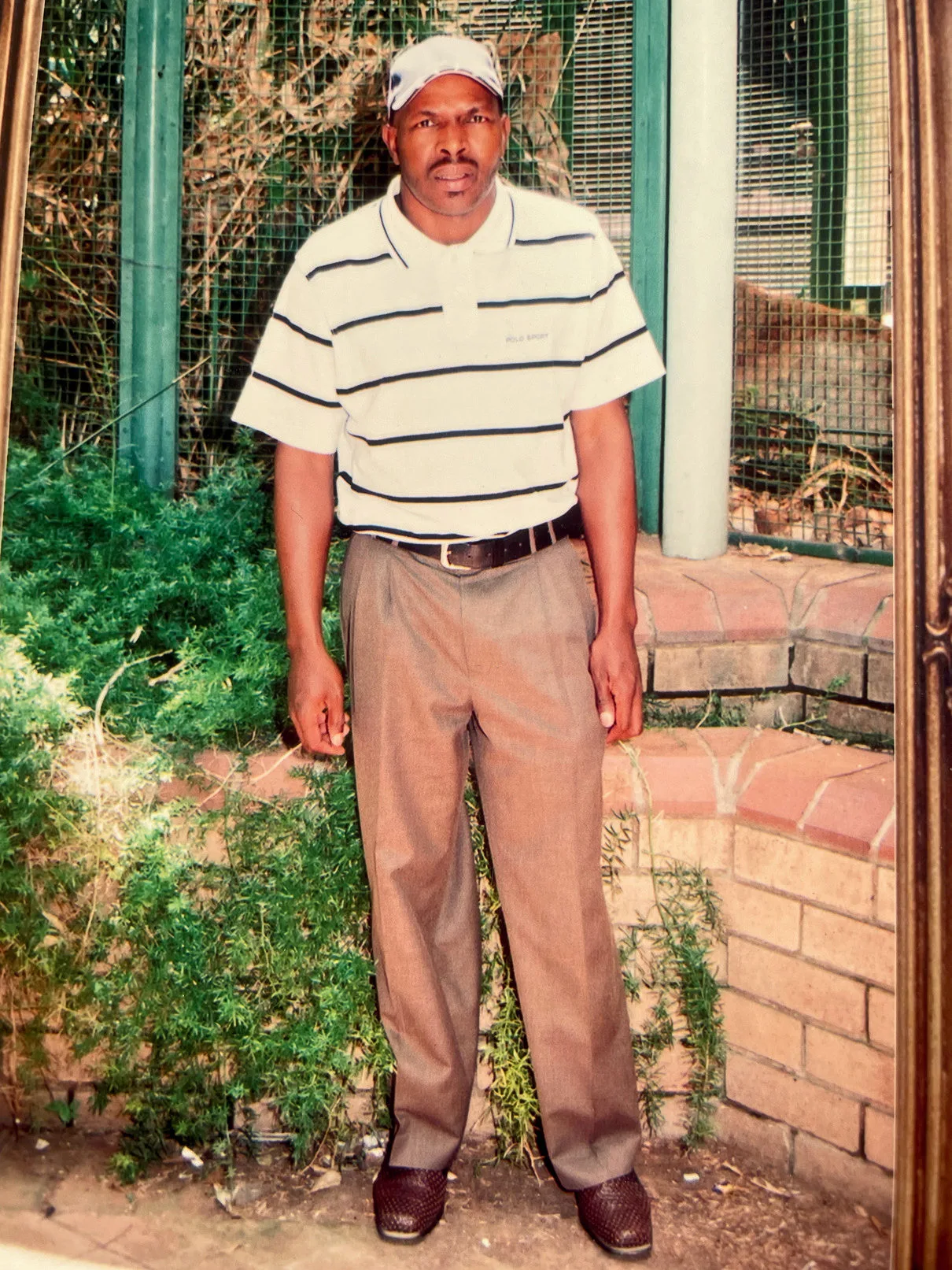 Motsokolane Joseph Ralikgomo standing outside the family home